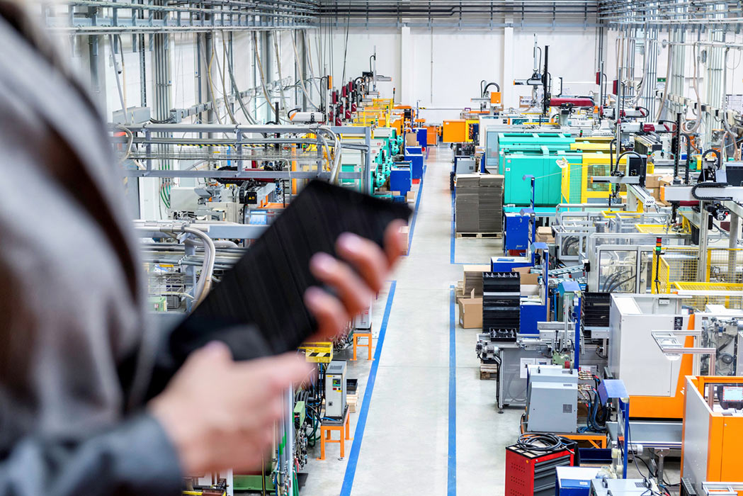 Procurement Professional in Warehouse Holding a Tablet