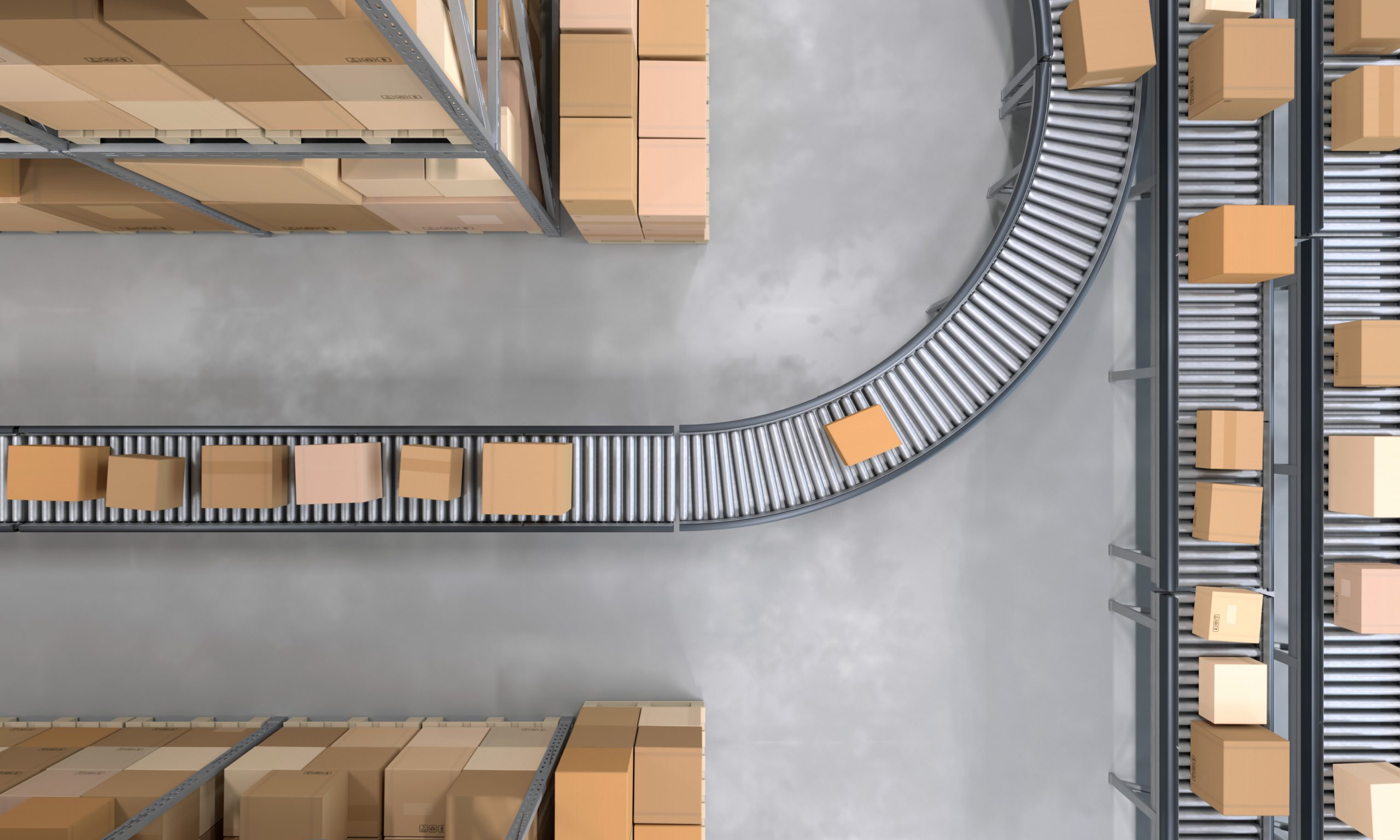 Top view of conveyor belts transporting boxes in a large warehouse Supplier Risk: The Modern Guide To Secure Vendor Onboarding